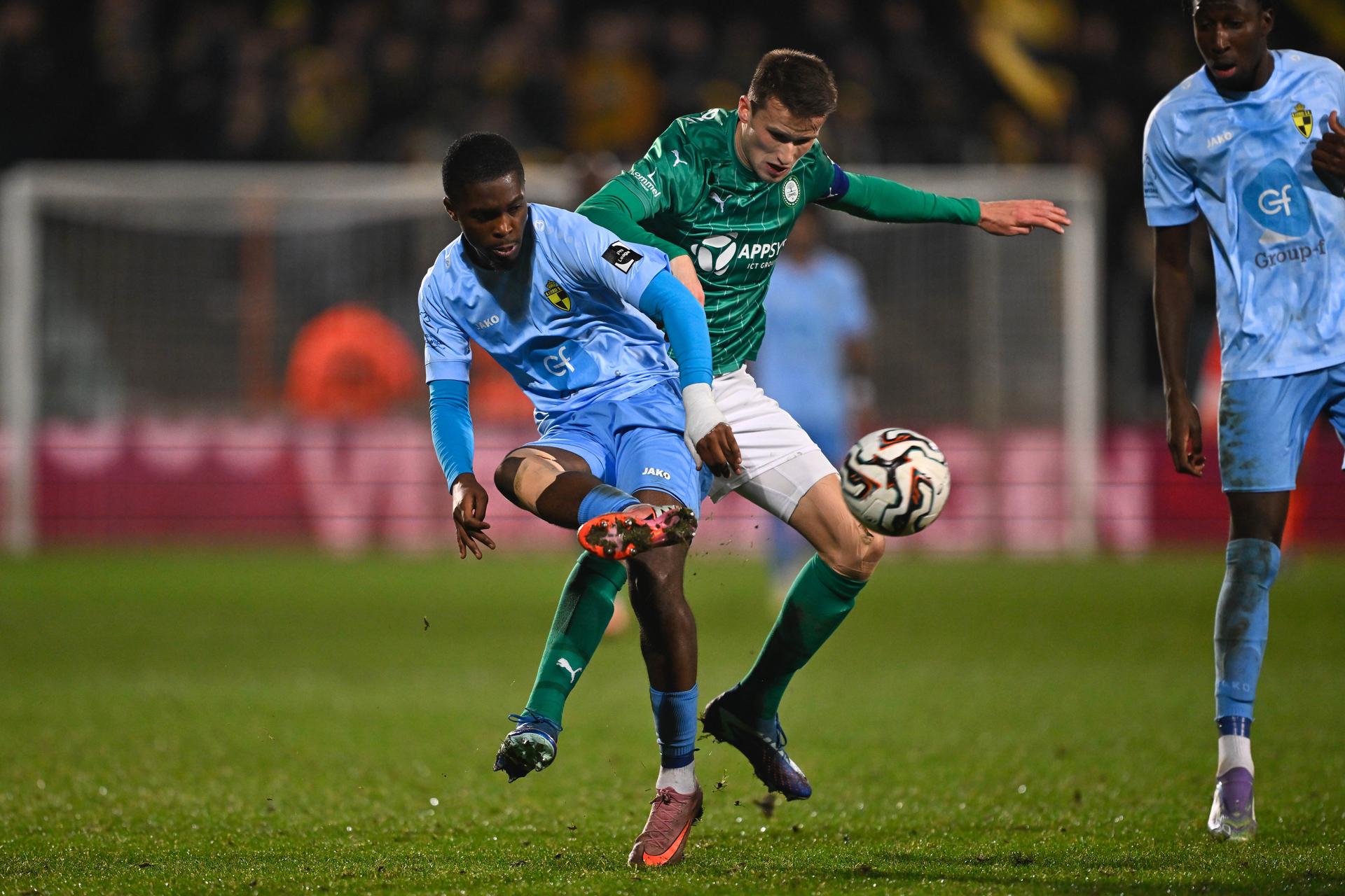 Lierse's Dirk Asare and Lommel's Lucas Schoofs fight for the ball during a soccer game between Lommel SK and Lierse SK, Friday 19 December 2025 in Lommel, on day 19 of the 2025-2026 'Challenger Pro League' 1B second division of the Belgian championship. BELGA PHOTO JOHAN EYCKENS