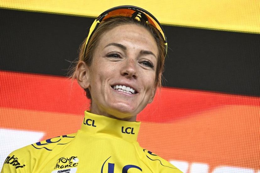 Team Visma | Lease a Bike's French rider Pauline Ferrand-Prevot celebrates with the overall leader's yellow jersey on the podium after winning the fourth edition of the Women's Tour de France cycling race at the end of the 9th and final stage, 124.1 km from Praz-sur-Arly to Chatel, in Chatel eastern France, on August 3, 2025.  JULIEN DE ROSA / AFP