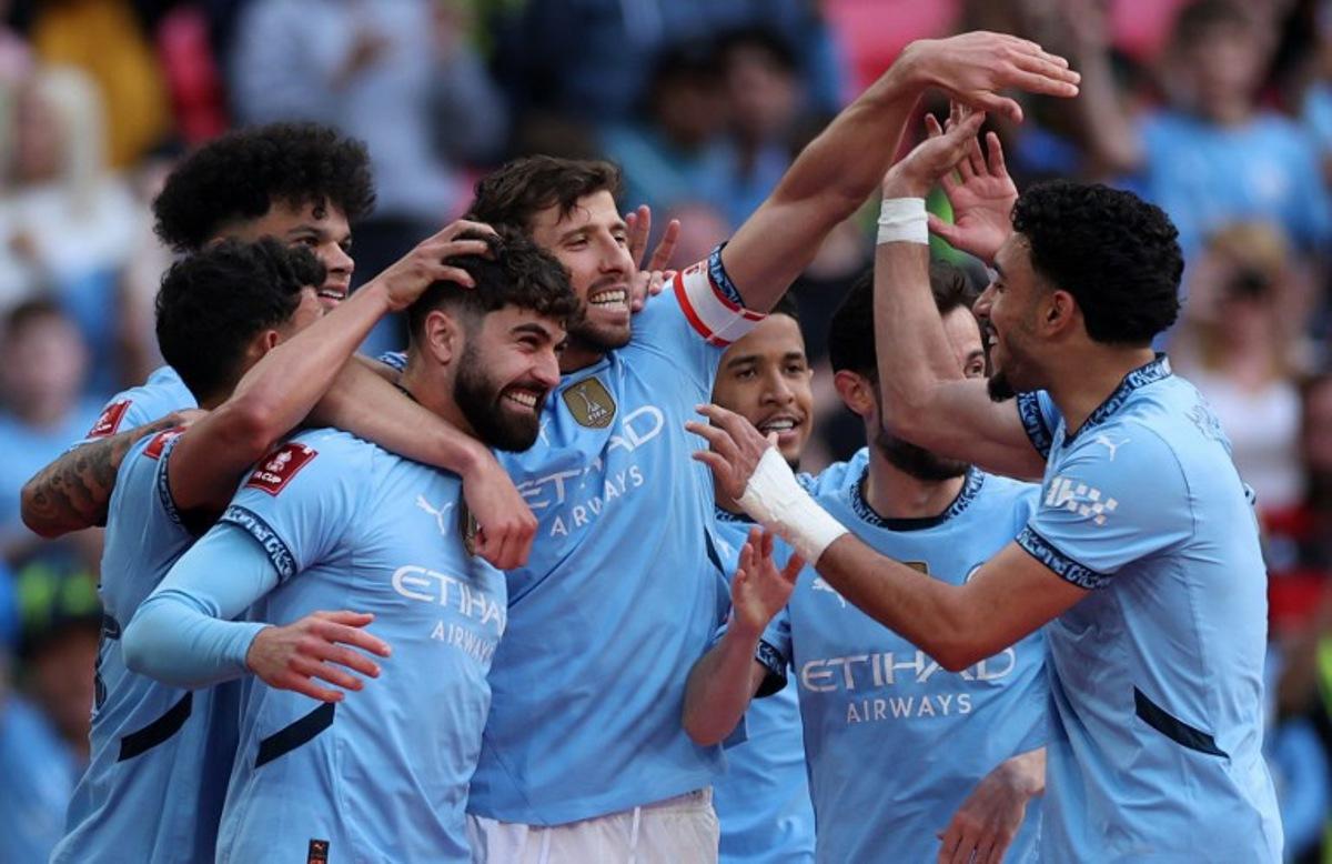 Manchester City's Croatian defender #24 Josko Gvardiol (3L) is mobbed by teammates after scoring the team's second goal during the English FA Cup semi-final football match between Nottingham Forest and Manchester City at Wembley Stadium in north London on April 27, 2025.  Adrian Dennis / AFP