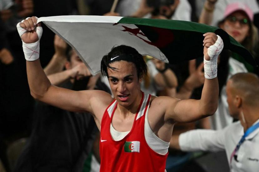 Algeria's Imane Khelif reacts after beating China's Yang Liu (Blue) in the women's 66kg final boxing match during the Paris 2024 Olympic Games at the Roland-Garros Stadium, in Paris on August 9, 2024.  Mauro PIMENTEL / AFP