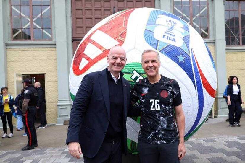 Canada's Prime Minister Mark Carney (R) and FIFA President Giovanni Infantino pose during the FIFA & Coca Cola World Cup Trophy Tour at Park Landsdowne Stadium in Ottawa, Canada, on May 24, 2026.  Dave Chan / AFP