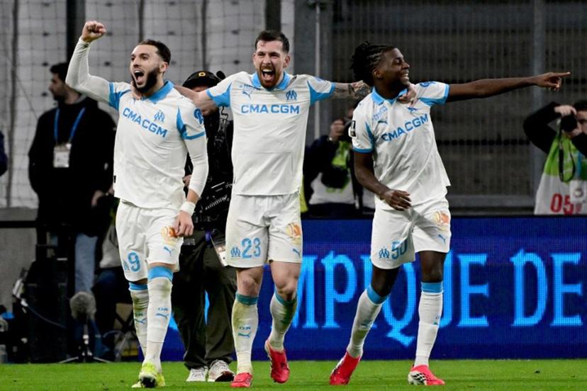 Marseille's Algerian forward #09 Amine Gouiri (L) celebrates with Marseille's Danish midfielder #23 Pierre-Emile Hojbjerg (C) and Marseille's French midfielder #50 Darryl Bakola (R) after scoring a goal during the French L1 football match between Olympique de Marseille (OM) and RC Lens at the Stade Velodrome in Marseille, southern France, on January 24, 2026.  Miguel MEDINA / AFP