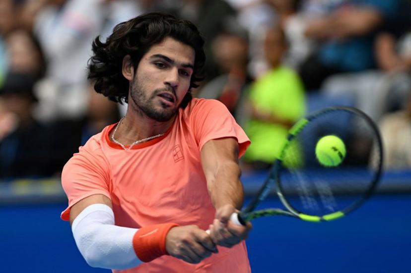 Spain's Carlos Alcaraz hits a return against Canada's Denis Shapovalov during their men's singles quarter-final tennis match at the ATP Tour Japan Open Tennis Championships at the Ariake Tennis Forest Park in Tokyo on October 4, 2026.  Rie KIKUCHI / AFP