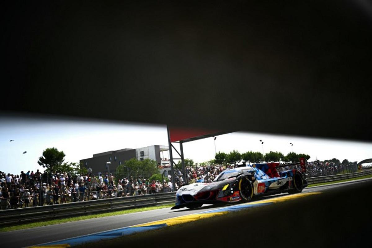 This photograph shows BMW M Team WRT's hypercar driven by Danish Kevin Magnussen, Italian Raffaele Marciello and Belgian Dries Vanthoor during the 94th edition of the 24 Hours of Le Mans at the Le Mans circuit, north-western France on June 13, 2026.  Lou BENOIST / AFP