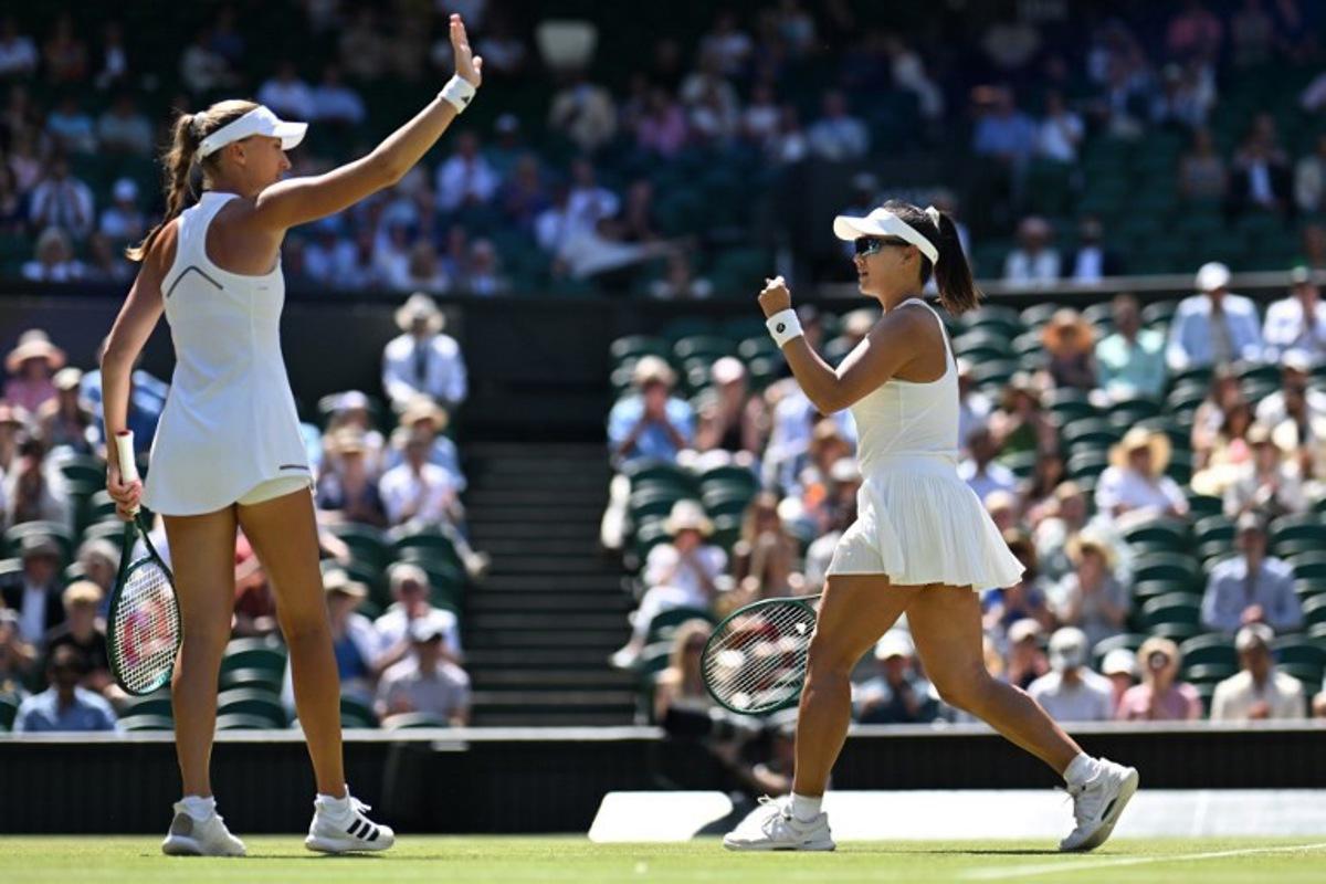 China's Guo Hanyu (R) and France's Kristina Mladenovic celebrate winning a point against Brazil's Luisa Stefani and Canada's Gabriela Dabrowski during their women's doubles final tennis match on the fourteenth day of the 2026 Wimbledon Championships at The All England Lawn Tennis and Croquet Club in Wimbledon, southwest London, on July 12, 2026.  Kirill KUDRYAVTSEV / AFP
