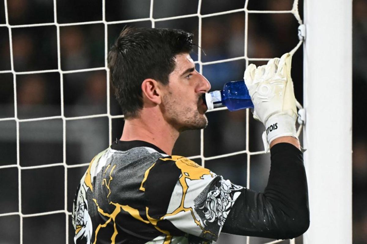 Real Madrid's Belgian goalkeeper #01 Thibaut Courtois drinks during the warming-up prior to the Spanish league football match between Elche CF and Real Madrid CF at Martinez Valero Stadium in Elche on November 23, 2025.  JOSE JORDAN / AFP