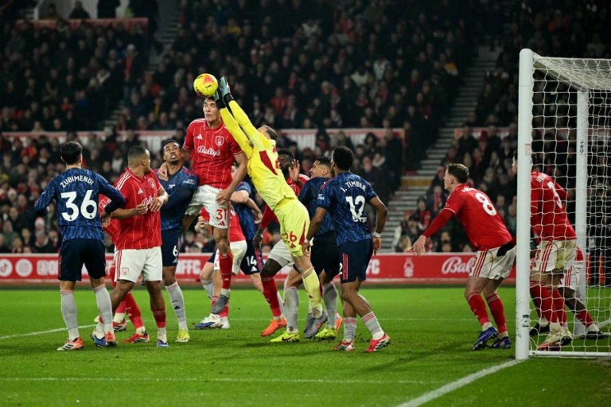 Nottingham Forest's Belgian goalkeeper #26 Matz Sels punches the ball away during the English Premier League football match between Nottingham Forest and Arsenal at The City Ground in Nottingham, central England, on January 17, 2026.  JUSTIN TALLIS / AFP