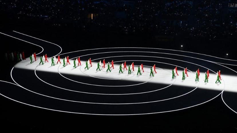 Performers dressed in colours of the Italian flag walk in lines during the opening ceremony of the Milano Cortina 2026 Winter Olympic Games at the San Siro stadium in Milan, northern Italy, on February 6, 2026.  PIERO CRUCIATTI / AFP