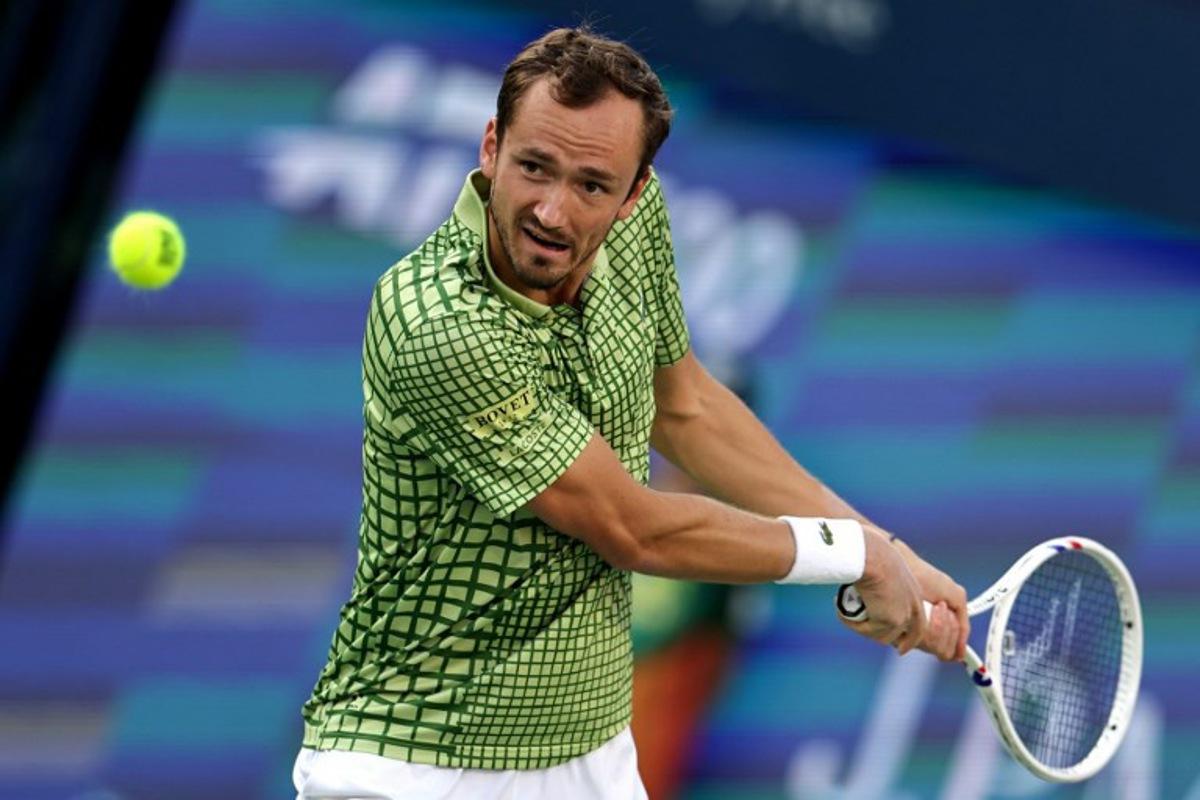 Russia's Daniil Medvedev hits a return against Canada's Felix Auger-Aliassime in the men's singles semi-final match at the Dubai Duty Free Tennis tournament in Dubai on February 27, 2026.  Fadel SENNA / AFP