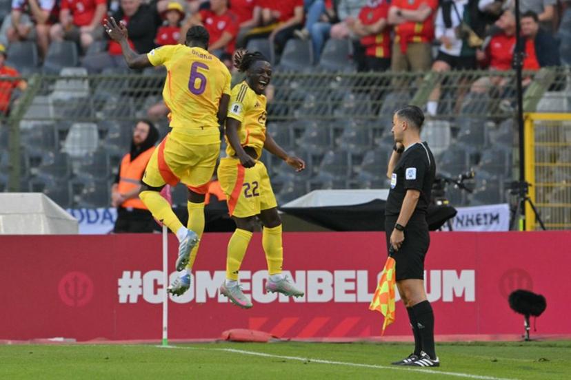 Belgium's forward #22 Jeremy Doku (C) celebrates with Belgium's midfielder #06 Amadou Onana (L) after scoring Belgium's third goal during the FIFA World Cup 2026 Group J European qualification football match between Belgium and Wales at the King Baudouin Stadium in Brussels, on June 9, 2025.  NICOLAS TUCAT / AFP