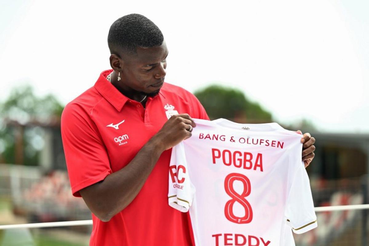 French midfielder Paul Pogba poses with his new jersey following his official presentation in Monaco, on July 3, 2025. Paul Pogba has signed a two-year deal with Ligue 1 side Monaco to return to football after a near two-year absence, the club announced on Juner 28, 2025. Frederic DIDES / AFP