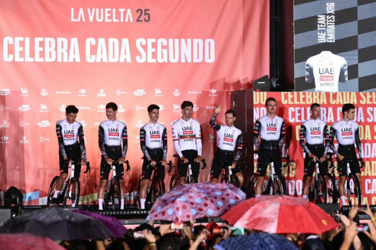 UAE Team Emirates XRG riders stand on stage during the official teams presentation of the 80th edition of 'La Vuelta' cycling tour of Spain, in Torino, Italy on August 21, 2025.  Marco BERTORELLO / AFP