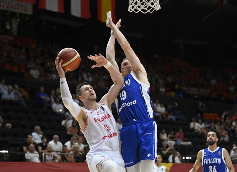 Poland's forward #09 Mateusz Ponitka vies for the ball with Finland's forward #19 Elias Valtonen during the 2024 FIBA Olympic Qualifying Tournament basketball match between Poland and Finland in Valencia, on July 4, 2024.  JOSE JORDAN / AFP