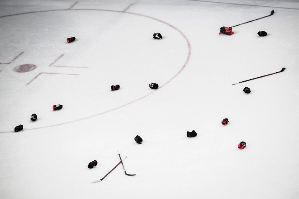 Canadian players' gloves and sticks are seen after their victory during the women's gold medal match of the Beijing 2022 Winter Olympic Games ice hockey competition between Canada and USA, at the Wukesong Sports Centre in Beijing on February 17, 2022.  Jeff PACHOUD / AFP