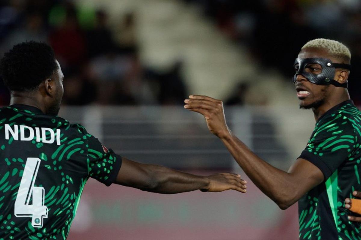 Nigeria's midfielder #04 Wilfred Ndidi and Nigeria's forward #09 Victor Osimhen react during the Africa Cup of Nations (CAN) round of 16 football match between Nigeria and Mozambique at the Sports Complex stadium in Fes on January 5, 2026.   Abdel Majid BZIOUAT / AFP