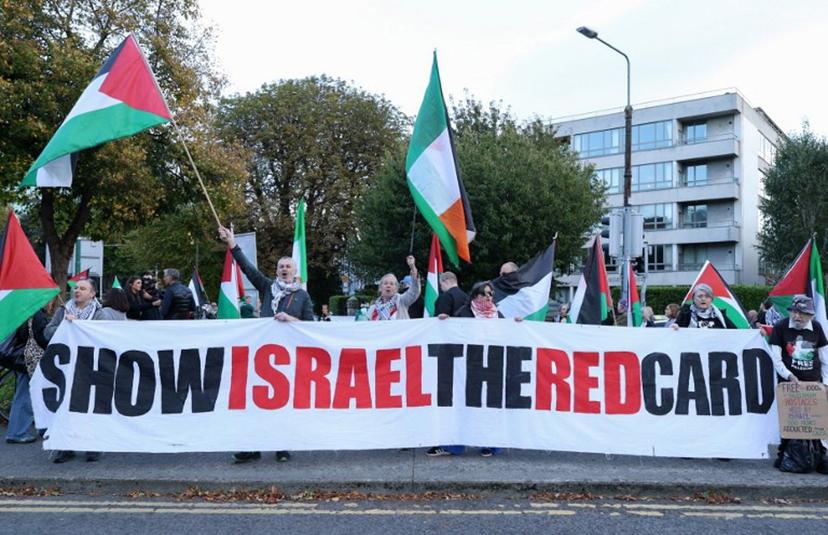 People hold placards calling on Ireland's football team not to play their next fixture against Israel, during a 'Stop The Game' protest outside Aviva Stadium in Dublin on October 1, 2026, ahead of the team's Nations League match against Austria. Ireland coach Heimir Hallgrimsson said on September 30 they will play their second Nations League match against Israel on October 4 after the first fixture was thrown into doubt by player concerns over the Gaza war. Paul Faith / AFP