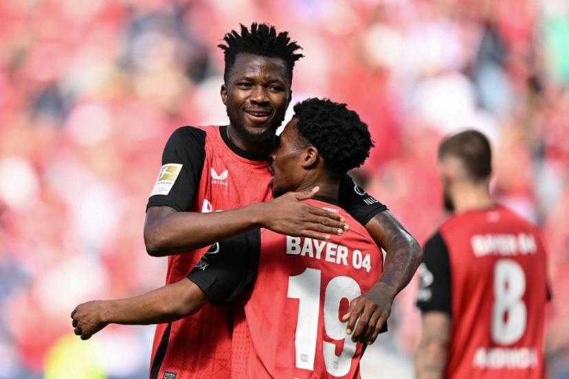 Bayer Leverkusen's English midfielder #19 Nathan Tella (front) celebrates the opening goal with team mate Bayer Leverkusen's Nigerian forward #22 Victor Boniface during the German first division Bundesliga football match between Bayer 04 Leverkusen and FC Augsburg in Leverkusen, western Germany on April 26, 2025.  INA FASSBENDER / AFP