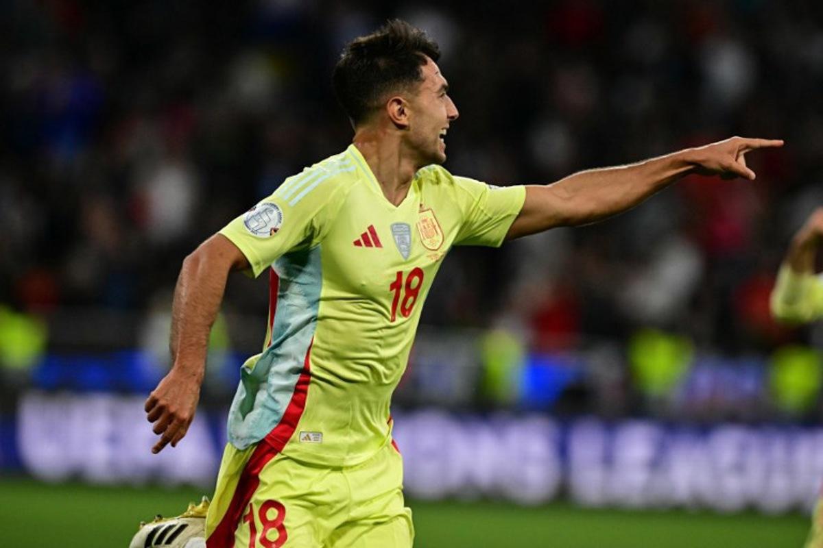 Spain's midfielder #18 Martin Zubimendi celebrates scoring the opening goal with his teammates during the UEFA Nations League final football match between Portugal and Spain in Munich, southern Germany on June 8, 2025.  Tobias SCHWARZ / AFP