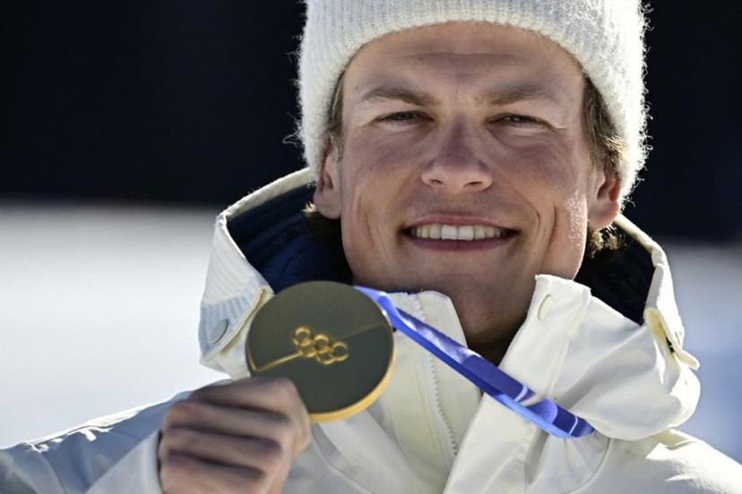 Gold medallist Norway's Johannes Hoesflot Klaebo celebrates on the podium for the men's 10km cross-country interval start free event of the Milano Cortina 2026 Winter Olympic Games at Tesero Cross-Country Skiing Stadium in Lago di Tesero (Val di Fiemme) on February 13, 2026.  Tobias SCHWARZ / AFP