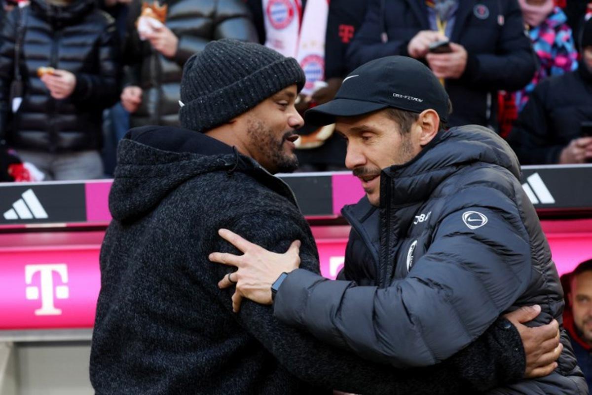 Bayern Munich's Belgian head coach Vincent Kompany (L) greets Freiburg's German head coach Julian Schuster prior to the German first division Bundesliga football match between FC Bayern Munich and SC Freiburg in Munich, southern Germany on November 22, 2025.  Karl-Josef HILDENBRAND / AFP