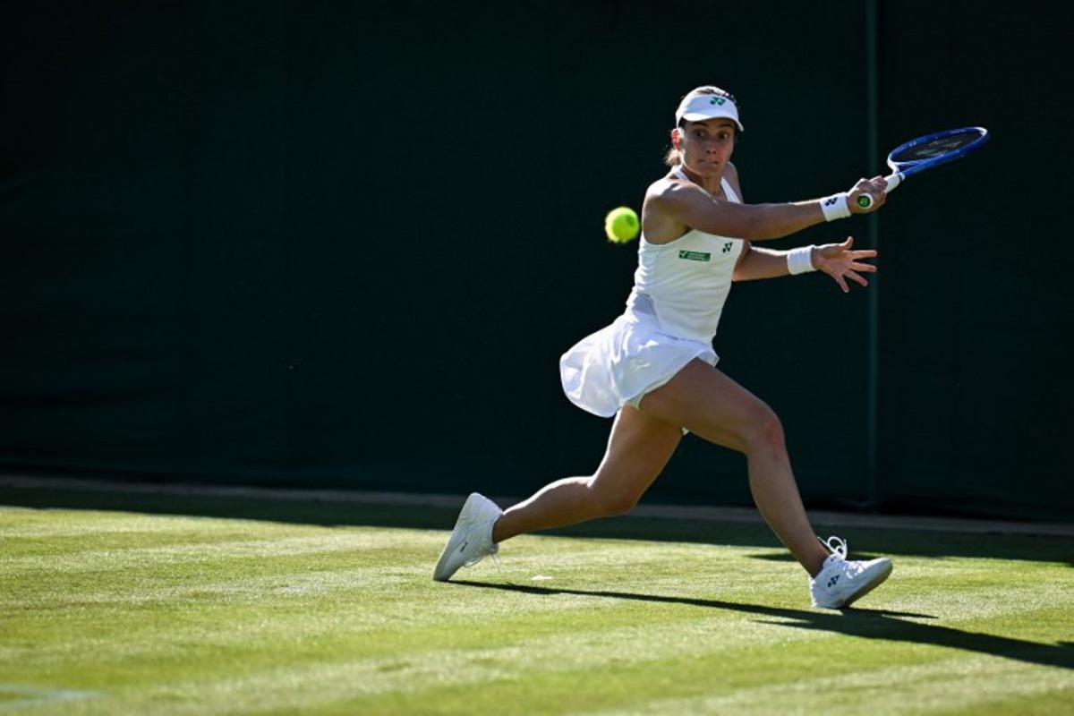 Latvia's Anastasija Sevastova plays a backhand return to Italy's Jasmine Paolini during their women's singles first round tennis match on the first day of the 2025 Wimbledon Championships at The All England Lawn Tennis and Croquet Club in Wimbledon, southwest London, on June 30, 2025.  Kirill KUDRYAVTSEV / AFP