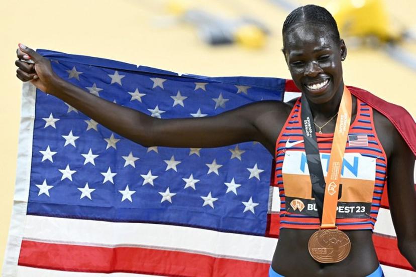 USA's bronze medallist Athing Mu celebrates with her medal and national flag after the women's 800m final during the World Athletics Championships at the National Athletics Centre in Budapest on August 27, 2023.  Attila KISBENEDEK / AFP