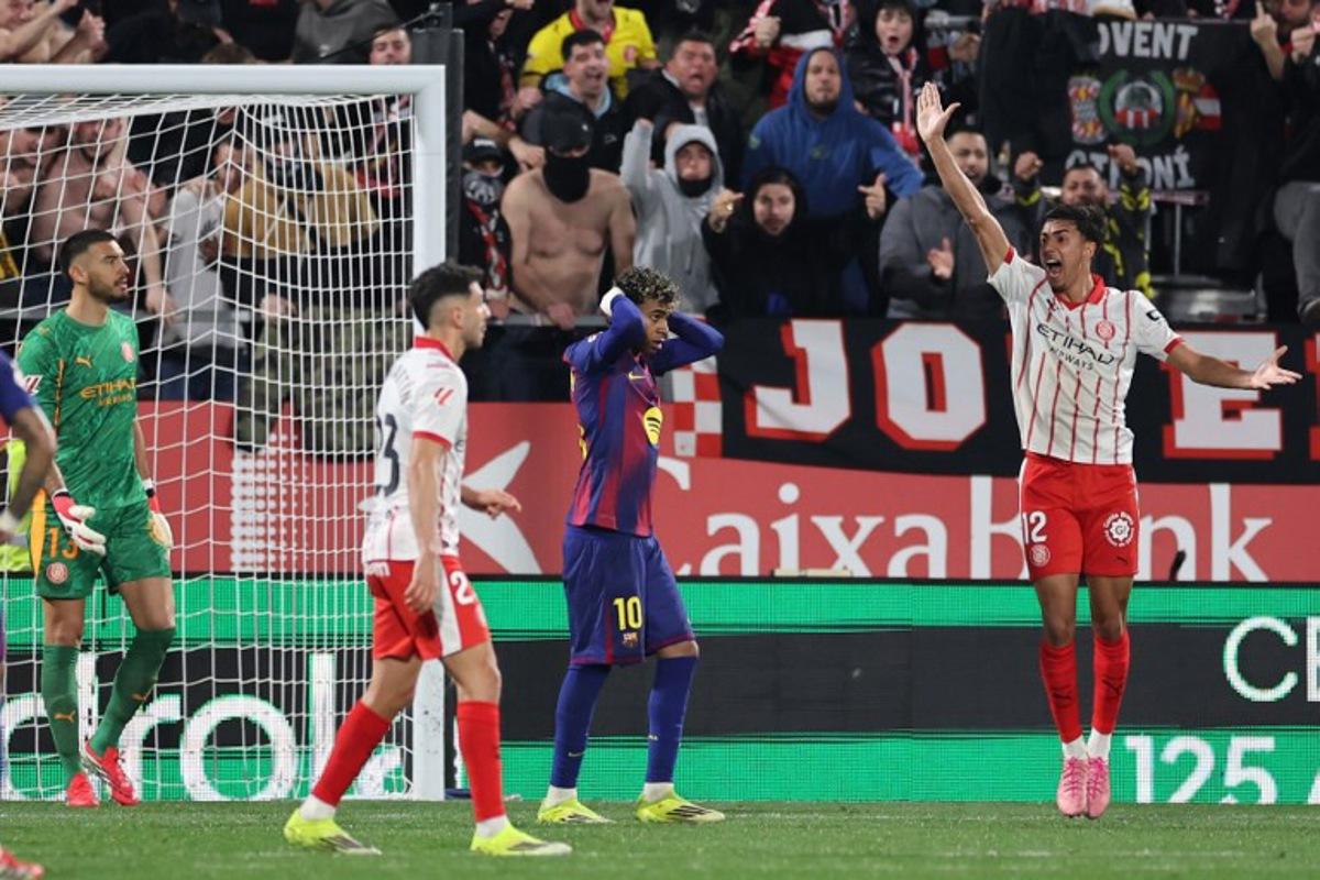 Barcelona's Spanish forward #10 Lamine Yamal reacts after failing to score a penalty kick during the Spanish league football match between Girona FC and FC Barcelona at Montilivi Stadium in Girona on February 16, 2026.  Josep LAGO / AFP