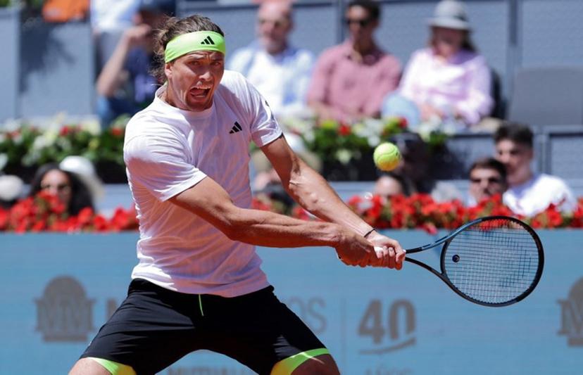 Germany's Alexander Zverev returns the ball to Spain's Alejandro Davidovich Fokina during their 2025 ATP Tour Madrid Open tennis tournament third round singles match at the Caja Magica in Madrid, on April 27, 2025.   Thomas COEX / AFP