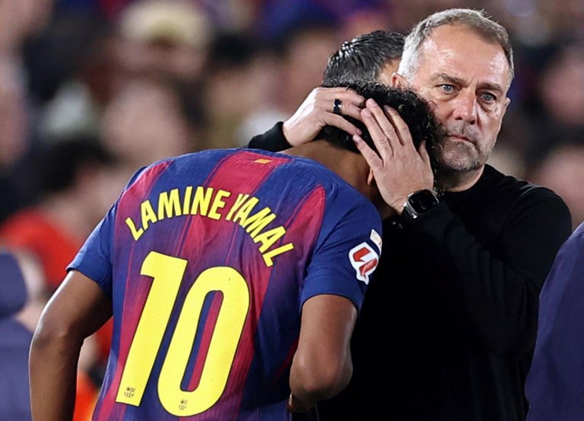 Barcelona's German coach Hans-Dieter Flick hugs Barcelona's Spanish forward #10 Lamine Yamal as he is substituted due to an injury during the Spanish league football match between FC Barcelona and RC Celta de Vigo at Camp Nou stadium in Barcelona on April 22 , 2026.  Josep LAGO / AFP