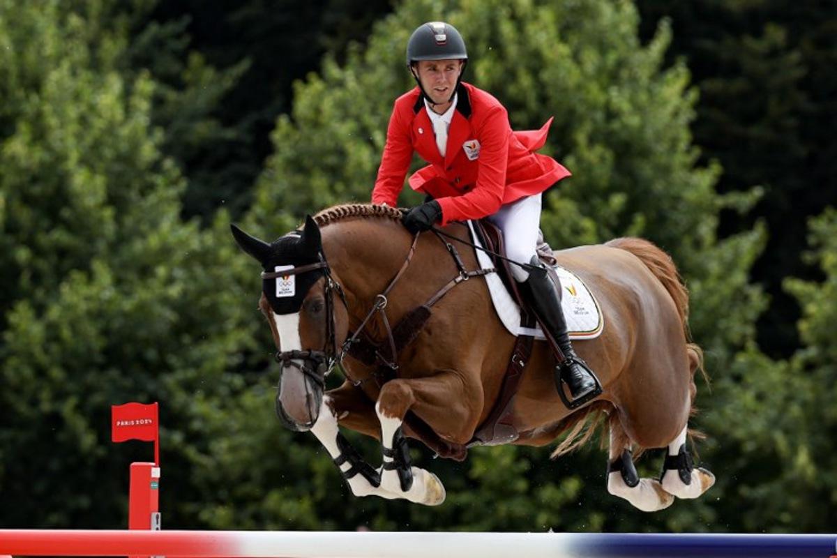 Belgium's Gilles Thomas with horse Ermitage Kalone competes in the equestrian's jumping team final during the Paris 2024 Olympic Games at the Chateau de Versailles, in Versailles, in the western outskirts of Paris, on August 2, 2024.  Pierre-Philippe MARCOU / AFP