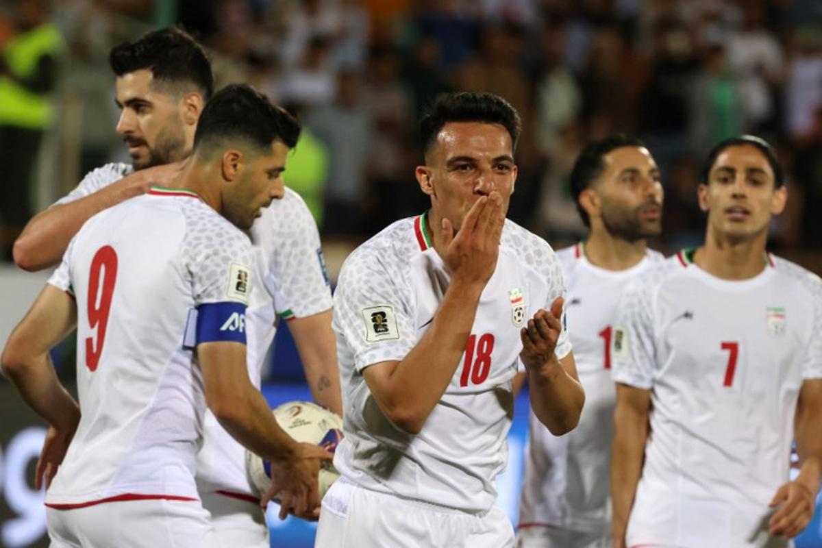 Iran's midfielder #18 Amirhossein Hosseinzadeh celebrates scoring his team's third goal during the FIFA World Cup 2026 Asia zone qualifiers group A football match between Iran and the North Korea at the Azadi Sports Complex in Tehran on June 10, 2025.  ATTA KENARE / AFP