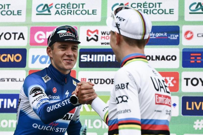 Second-placed Soudal Quick-Step team's Belgian rider Remco Evenepoel (L) shakes hands with winner UAE Team Emirates team's Slovenian rider Tadej Pogacar (R) on the podium after the 118th edition of the Giro di Lombardia (Tour of Lombardy), a 252km cycling race from Bergamo to Como on October 12, 2024.  Marco BERTORELLO / AFP