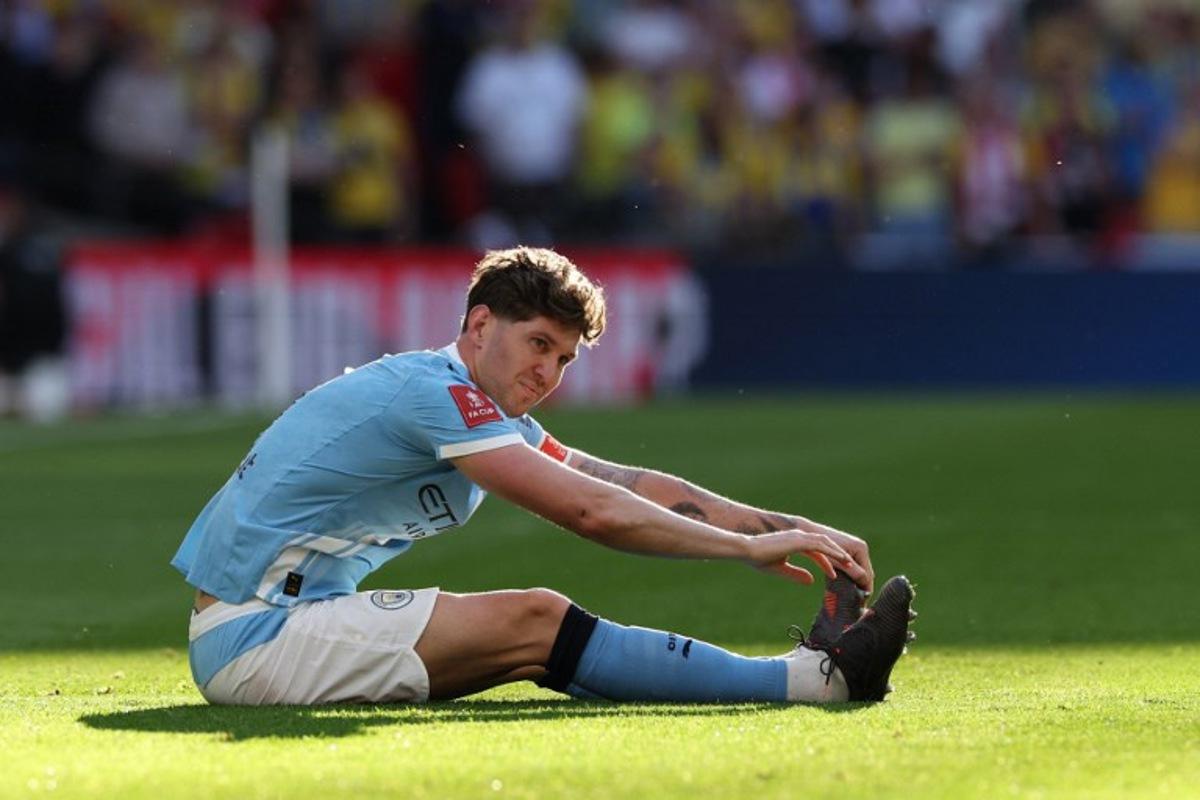 Manchester City's English defender #05 John Stones reacts after suffering a knock during the English FA Cup semi final football match between Manchester City and Southampton at Wembley stadium in London, on April 25, 2026.  Adrian Dennis / AFP