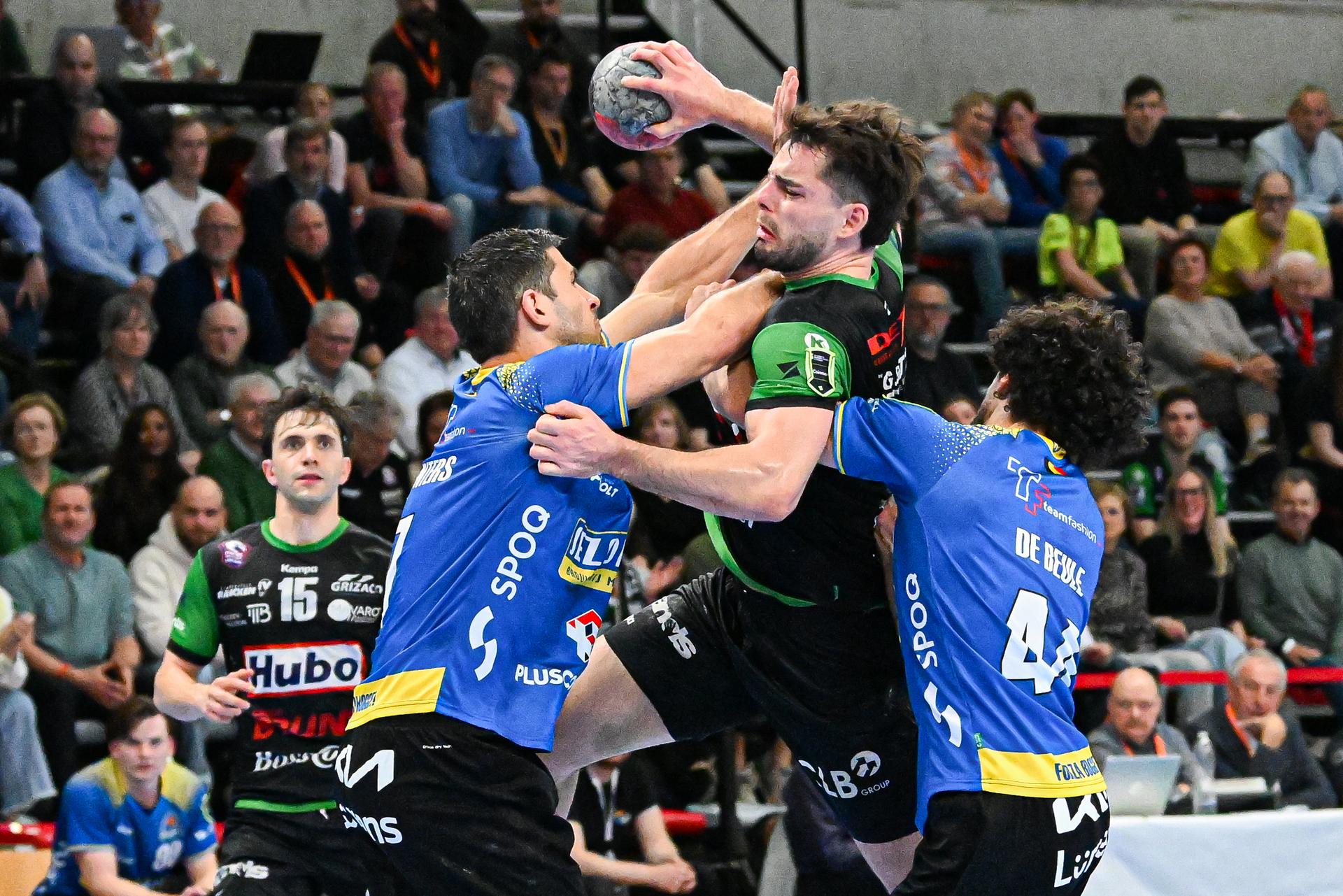Bocholt's Wout Winters, Hubo Handbal's Sebastien Danesi and Bocholt's Jeroen De Beule pictured in action during a handball game between Achilles Bocholt and HUBO Handbal, Saturday 04 April 2026, in Hasselt, the men's final of the Belgian handball cup. BELGA PHOTO JILL DELSAUX