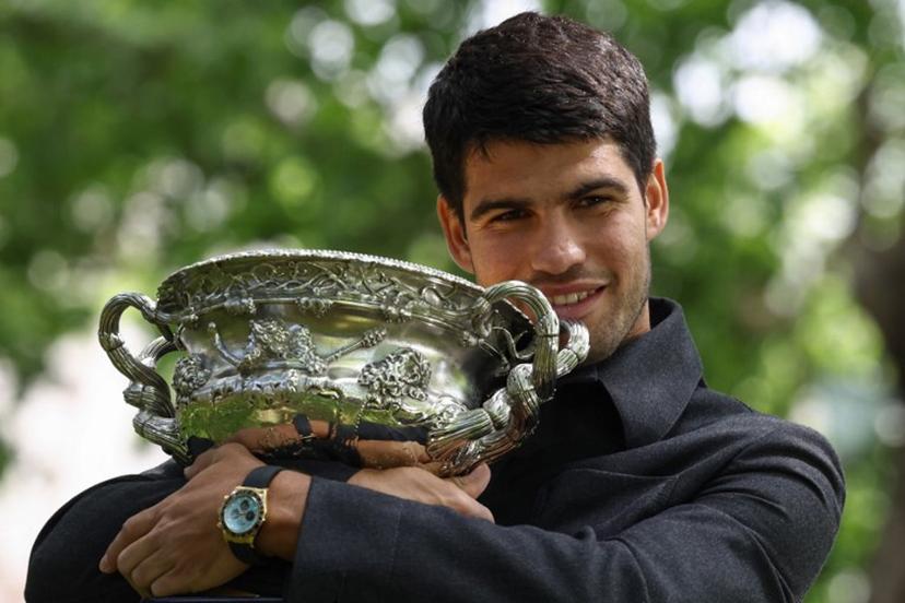 Spain's Carlos Alcaraz poses with the Norman Brookes Challenge Cup at the Royal Exhibition Building following his victory against Serbia's Novak Djokovic in the men's singles final match of the Australian Open tennis tournament in Melbourne on February 2, 2026.  David GRAY / AFP
