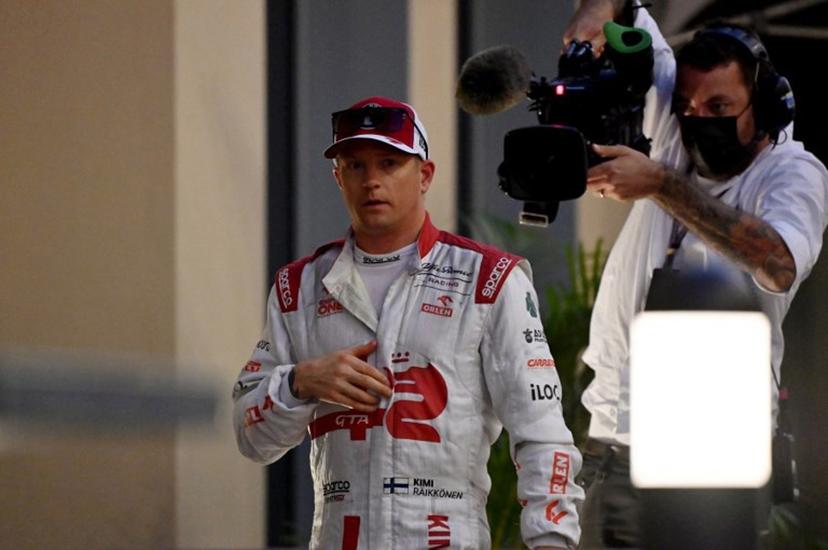Alfa Romeo's Finnish driver Kimi Raikkonen walks back in his team's hospitality after he retired from the race at the Yas Marina Circuit during the Abu Dhabi Formula One Grand Prix on December 12, 2021.  ANDREJ ISAKOVIC / AFP