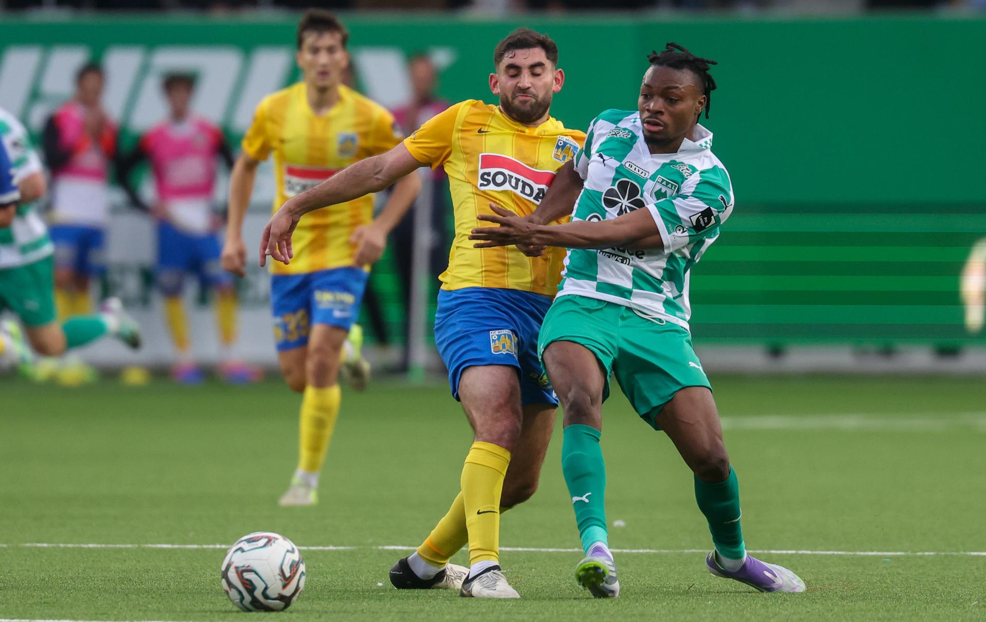 Westerlo's Dogucan Haspolat and RAAL's Jerry Afriyie fight for the ball during a soccer match between RAAL La Louviere and KVC Westerlo, Saturday 18 October 2025 in La Louviere, on day 11 of the 2025-2026 'Jupiler Pro League' first division of the Belgian championship. BELGA PHOTO VIRGINIE LEFOUR