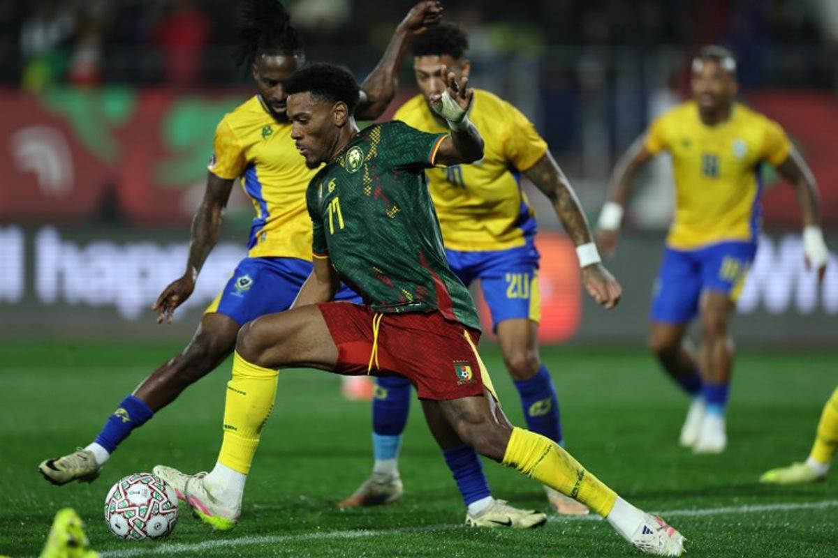Cameroon's defender #17 Samuel Kotto runs with the ball during the Africa Cup of Nations (CAN) Group F football match between Cameroon and Gabon at Adrar Stadium in Agadir on December 24, 2025.   FRANCK FIFE / AFP