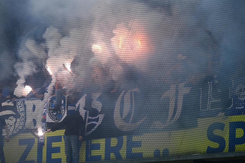 Supporters with fireworks and smoke bombs pictured during a soccer match between Sint-Truidense V.V. and KRC Genk, Sunday 28 September 2025 in Sint-Truiden, on day 9 of the 2025-2026 'Jupiler Pro League' first division of the Belgian championship. BELGA PHOTO JILL DELSAUX