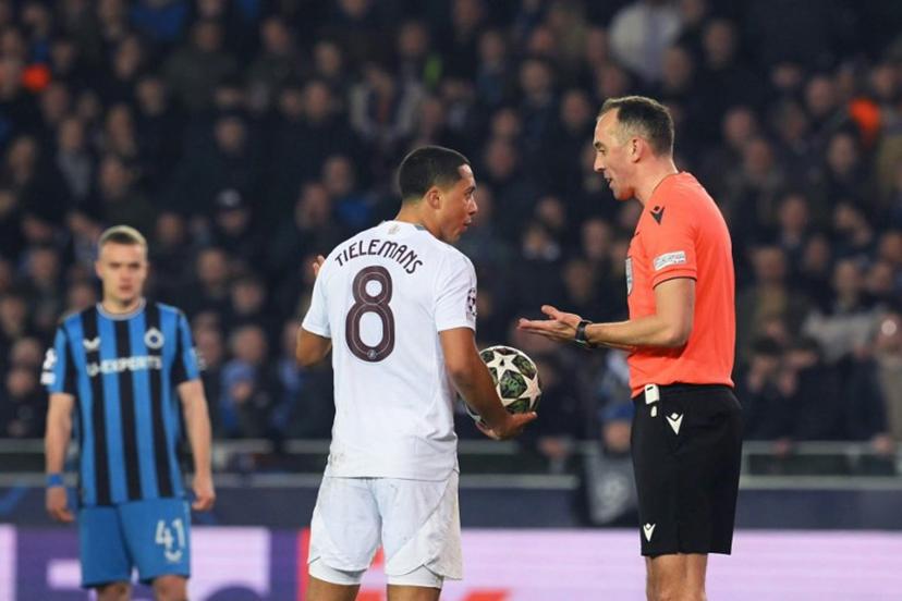 Aston Villa's Belgian midfielder #08 Youri Tielemans (C) speaks with Portuguese referee Joao Pinheiro (R)  during the UEFA Champions League round of 16 first leg football match between Club Brugge KV and Aston Villa FC at the Jan Breydel Stadium in Bruges, on March 4, 2025.  NICOLAS TUCAT / AFP