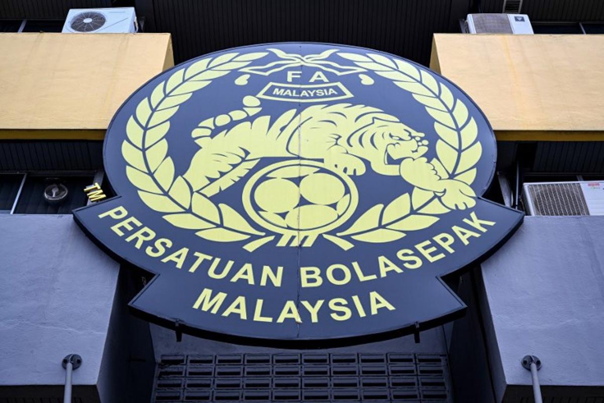 The logo of the Malaysian football association (FAM) is pictured at the FAM's headquarters in Kuala Lumpur on January 28, 2026. The Malaysian football association's entire executive committee resigned on January 28, due to an ongoing eligibility scandal linked to forged documents used in Asian Cup qualifying games. Mohd Rasfan / AFP