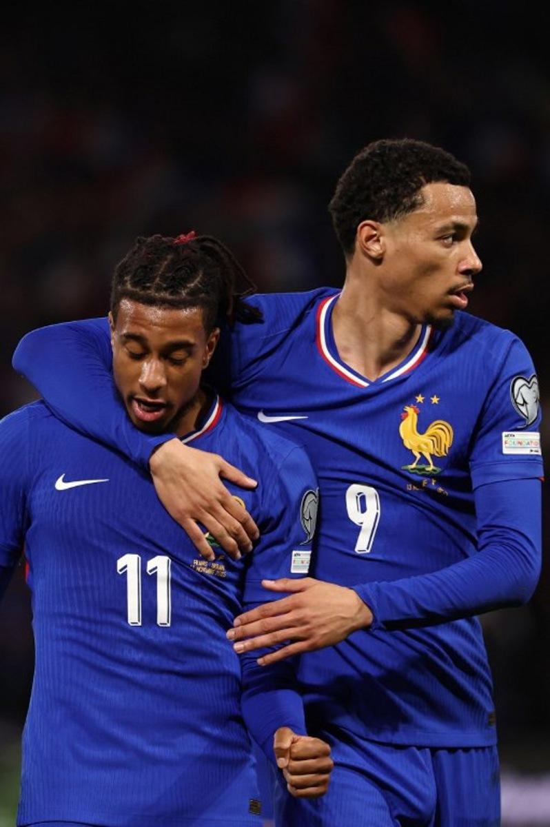 France's forward #11 Michael Olise (L) celebrates after scoring his team second goal with France's forward #09 Hugo Ekitike during the 2026 World Cup qualifiers Europe zone group D football match between France and Ukraine at the Parc des Princes stadium in Paris, on November 13, 2025.   FRANCK FIFE / AFP
