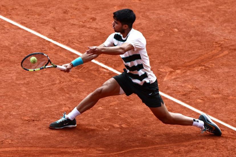 Spain's Carlos Alcaraz plays a backhand return to Italy's Jannik Sinner during their men's singles final match on day 15 of the French Open tennis tournament on Court Philippe-Chatrier at the Roland-Garros Complex in Paris on June 8, 2025.  Thibaud MORITZ / AFP