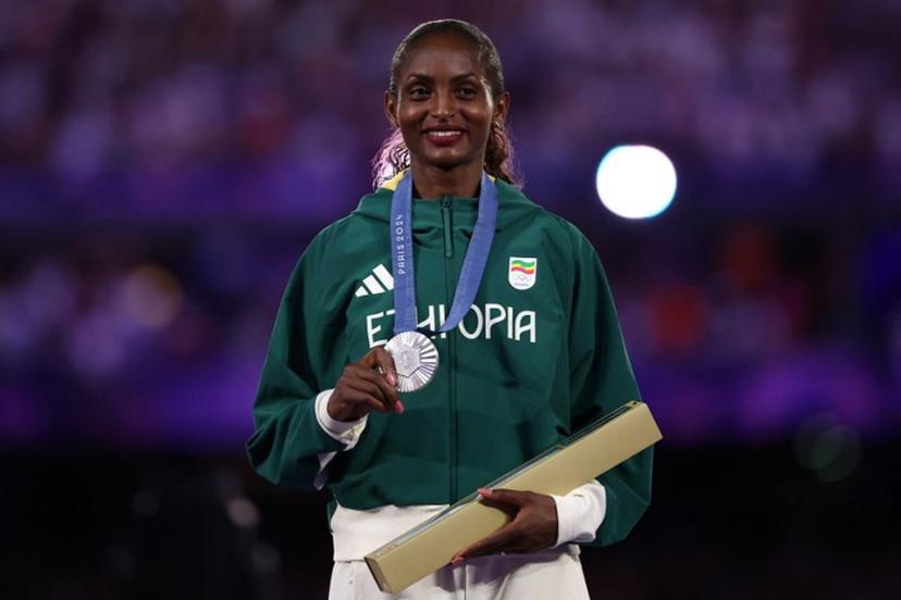 Silver medallist Ethiopia's Tigist Assefa poses during the podium ceremony for the women's marathon of the athletics event during the closing ceremony of the Paris 2024 Olympic Games at the Stade de France, in Saint-Denis, in the outskirts of Paris, on August 11, 2024.  Franck FIFE / AFP