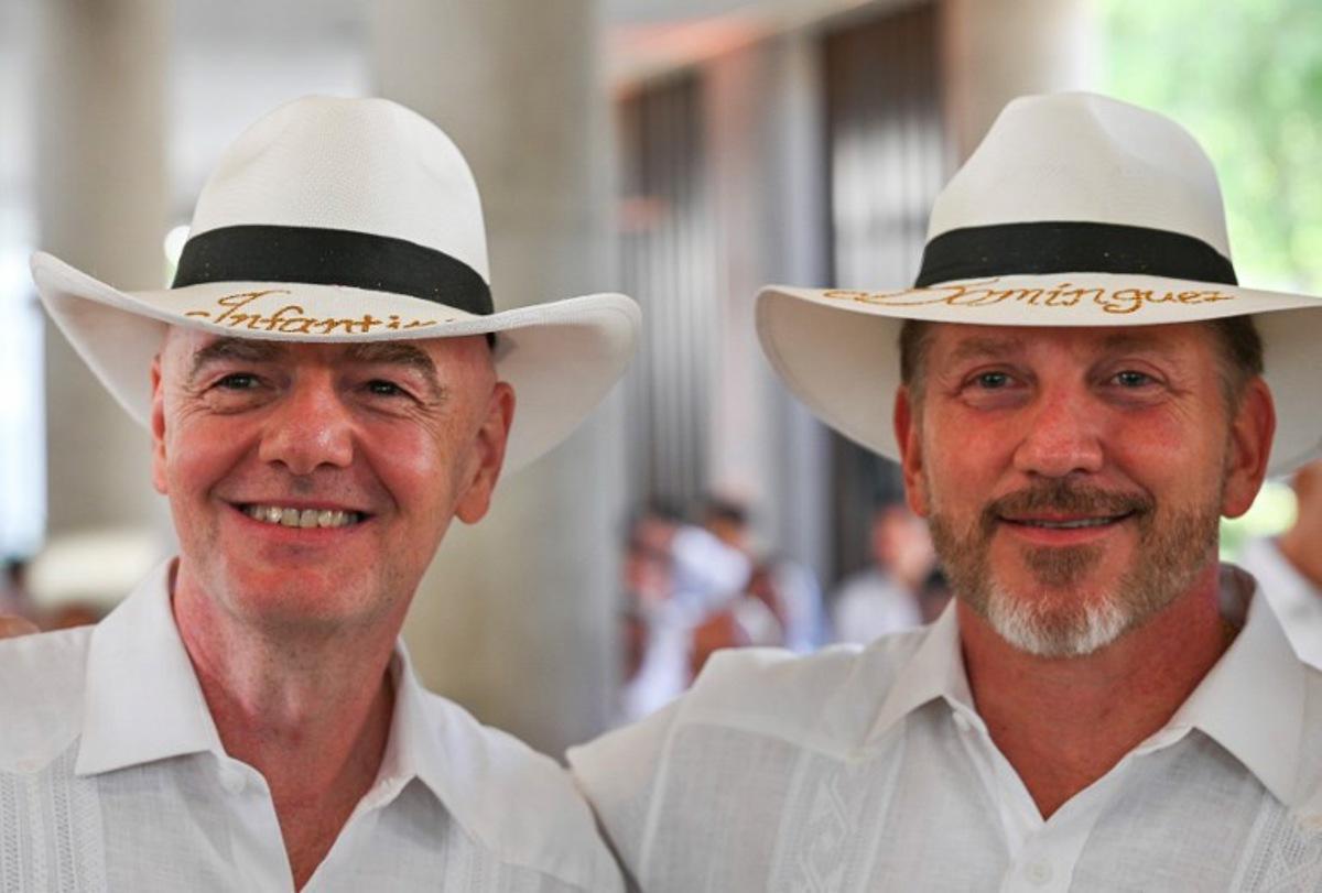 FIFA president Gianni Infantino (L) and CONMEBOL president Alejandro Dominguez wear typical Colombian hats reading 'Infantino' and 'Dominguez' during their visit to the new Concentration Hotel of the Colombian Football Federation, in Barranquilla, Colombia on February 24, 2026. FIFA boss Gianni Infantino told AFP on February 24, 2026, he was "very reassured" about Mexico's hosting of games in the World Cup, in his first comments on the violence triggered by the killing of a drug cartel leader. David SALAZAR / AFP