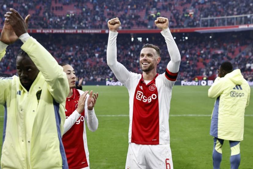 Ajax' Dutch midfielder Kian Fitz-Jim and Ajax's English midfielder #6 Jordan Henderson celebrate the victory of their team at the end of the Dutch Eredivisie football match between AFC Ajax and Feyenoord at the Johan Cruijff ArenA in Amsterdam, on February 2, 2025. Ajax won 2-12 over Feyenoord. MAURICE VAN STEEN / ANP / AFP
