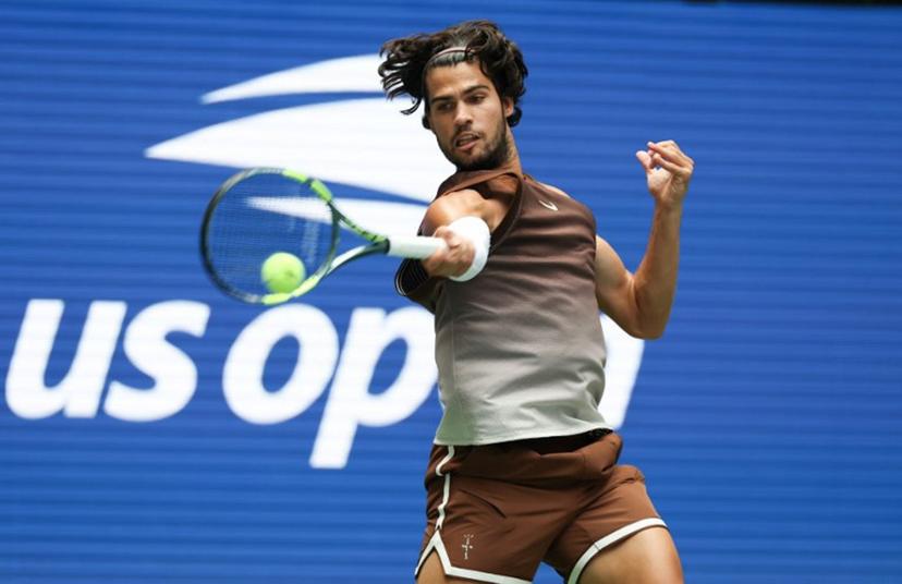 Spain's Carlos Alcaraz hits a return to Russia's Roman Safiullin during their men's singles first round tennis match on day two of the US Open tennis tournament at the USTA Billie Jean King National Tennis Center in New York City on August 31, 2026.  TIMOTHY A. CLARY / AFP