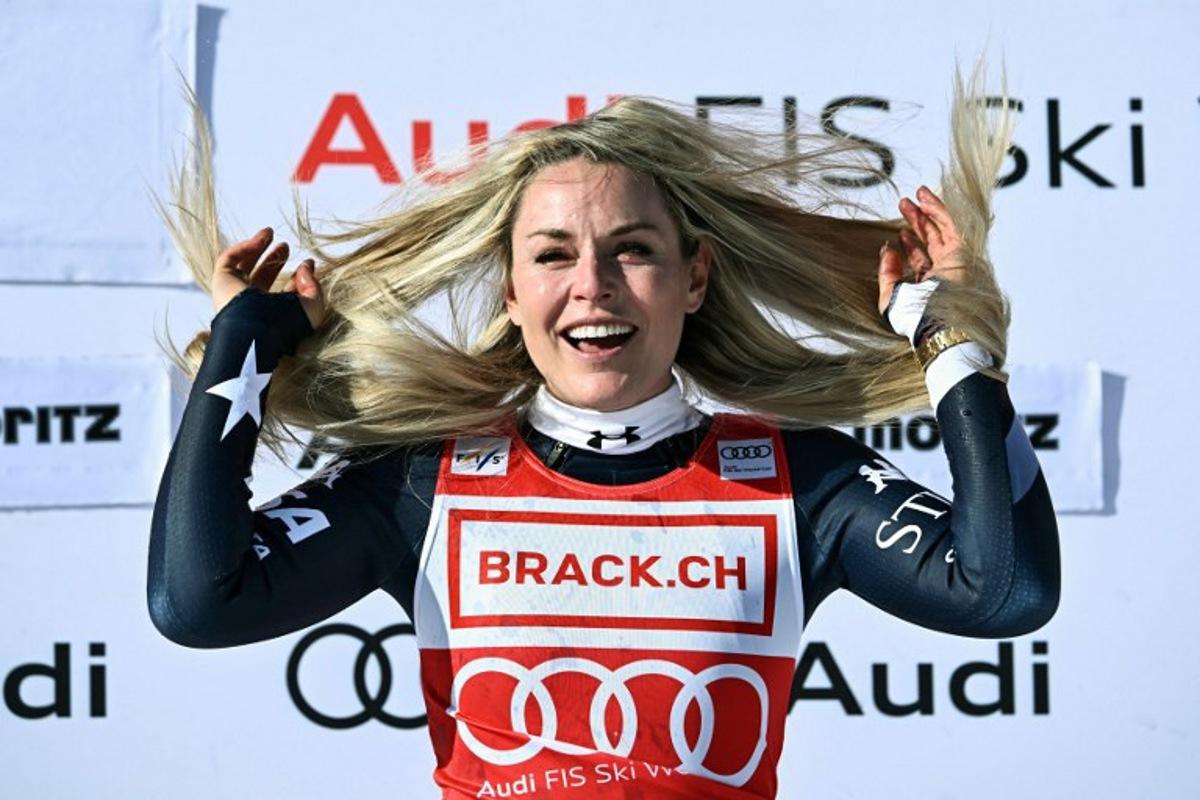 First-placed US Lindsey Vonn celebrates on the podium after competing in the women's downhill race during the FIS Alpine Ski World Cup 2025-2026, in St Moritz, south-eastern Switzerland on December 12, 2025.  Fabrice COFFRINI / AFP