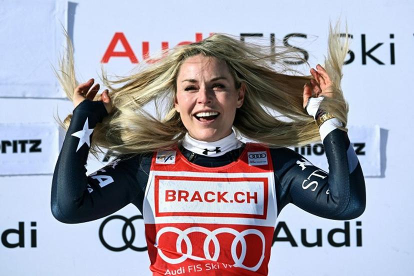 First-placed US Lindsey Vonn celebrates on the podium after competing in the women's downhill race during the FIS Alpine Ski World Cup 2025-2026, in St Moritz, south-eastern Switzerland on December 12, 2025.  Fabrice COFFRINI / AFP