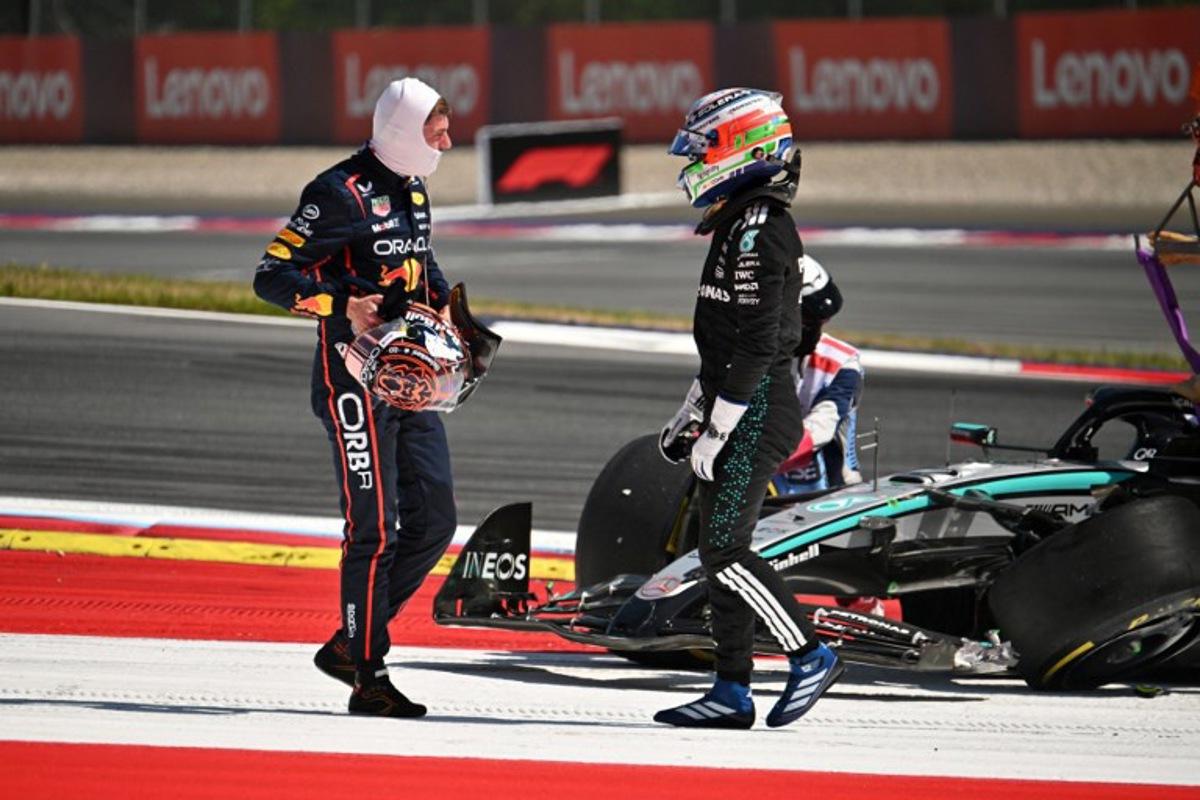 Red Bull's Dutch driver Max Verstappen (L) and Mercedes' Italian driver Kimi Antonelli speak after their cars crashed during the Formula One Austrian Grand Prix at the Red Bull Ring race track in Spielberg, Austria, on June 29, 2025.   Jure Makovec / AFP